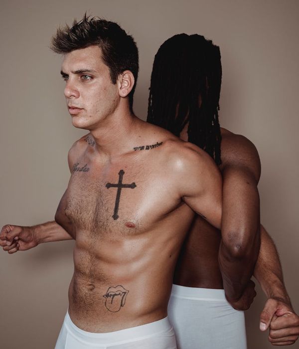 Man performing a controlled strength exercise in a modern gym.